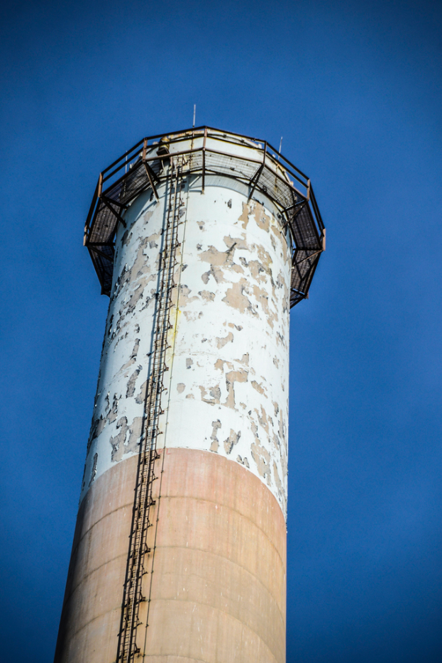 Ein groÃer Tanker mit einer eisernen Leiter und einem Zaun an der Oberseite.