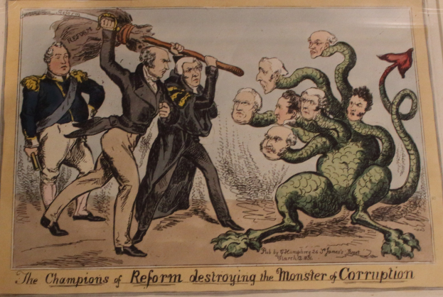 Cartoon-Illustration, die Figuren als Reformchampions darstellend, die ein als Korruption etikettiertes Monster besiegen, mit begleitendem Text.
