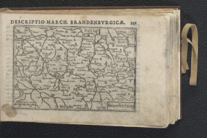 Open book displaying a detailed map of Brandenburg on a black surface.