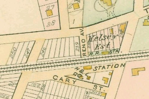 Old map of a city with numerous buildings, numbered sections, and text, labeled as land for sale at the bottom.
