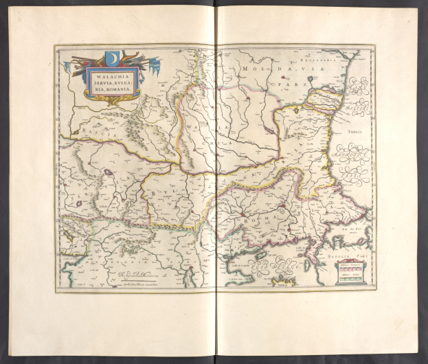 Open book with detailed maps of Poland and Hungary against a black background.