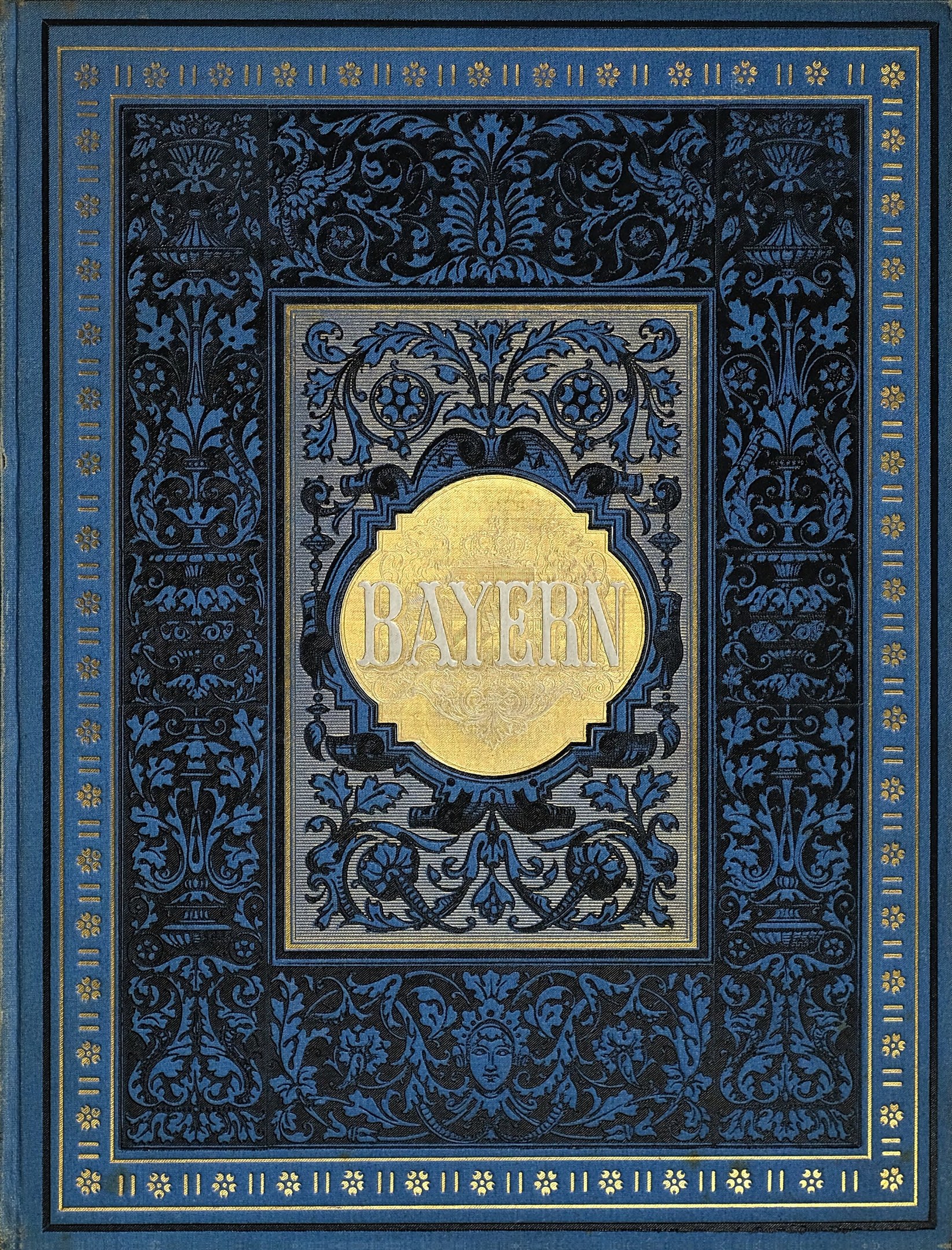 Ein blau-goldenes Buch mit der Aufschrift 'Bayern' auf dem Cover, das mit detaillierten dekorativen Designs verziert ist.