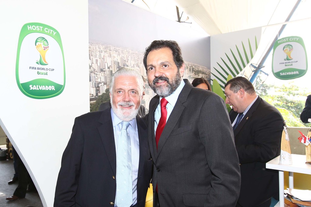 Eine Gruppe von Menschen, die mit einigen lächelnden Personen und einem FIFA-Weltmeisterschaftsposter im Hintergrund steht.