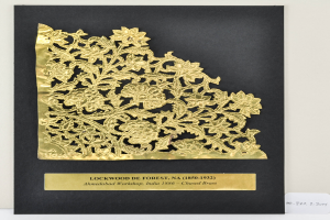 Eine schwarze und goldene Einladungskarte mit floralem Design und aufwendiger goldener Spitzenverzierung auf weißem Hintergrund.